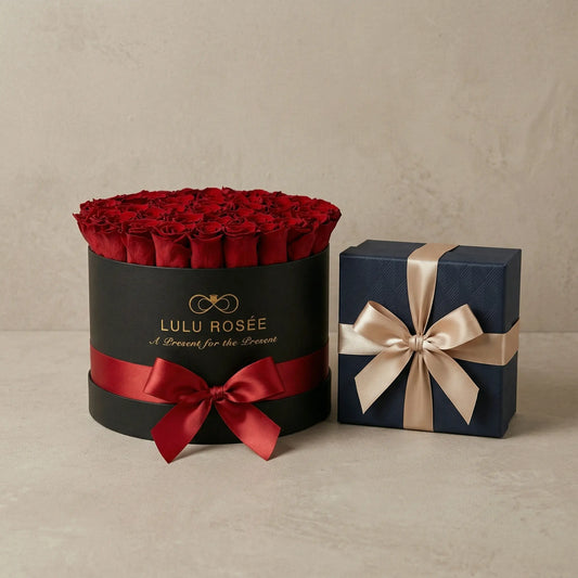 Black box with red roses and a red ribbon, next to a blue gift box with a beige ribbon on a beige background.