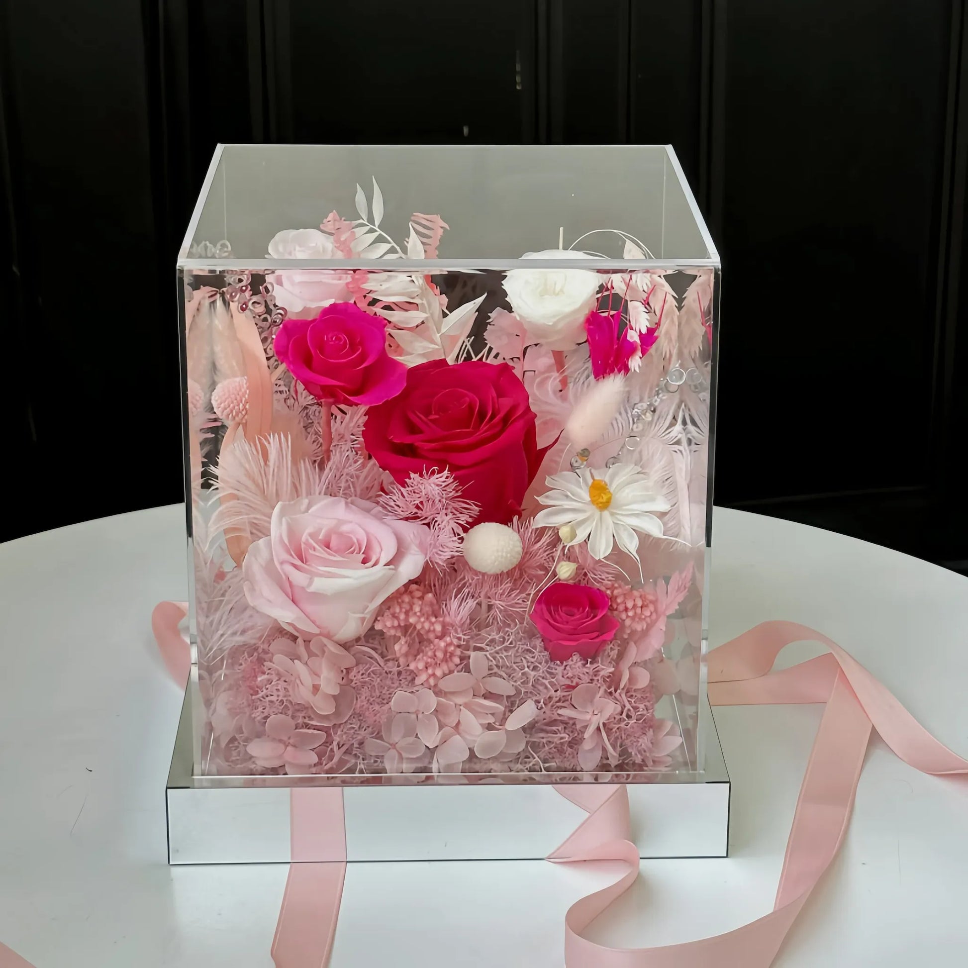 LULU ROSÉE pink flame rose acrylic box on a white surface