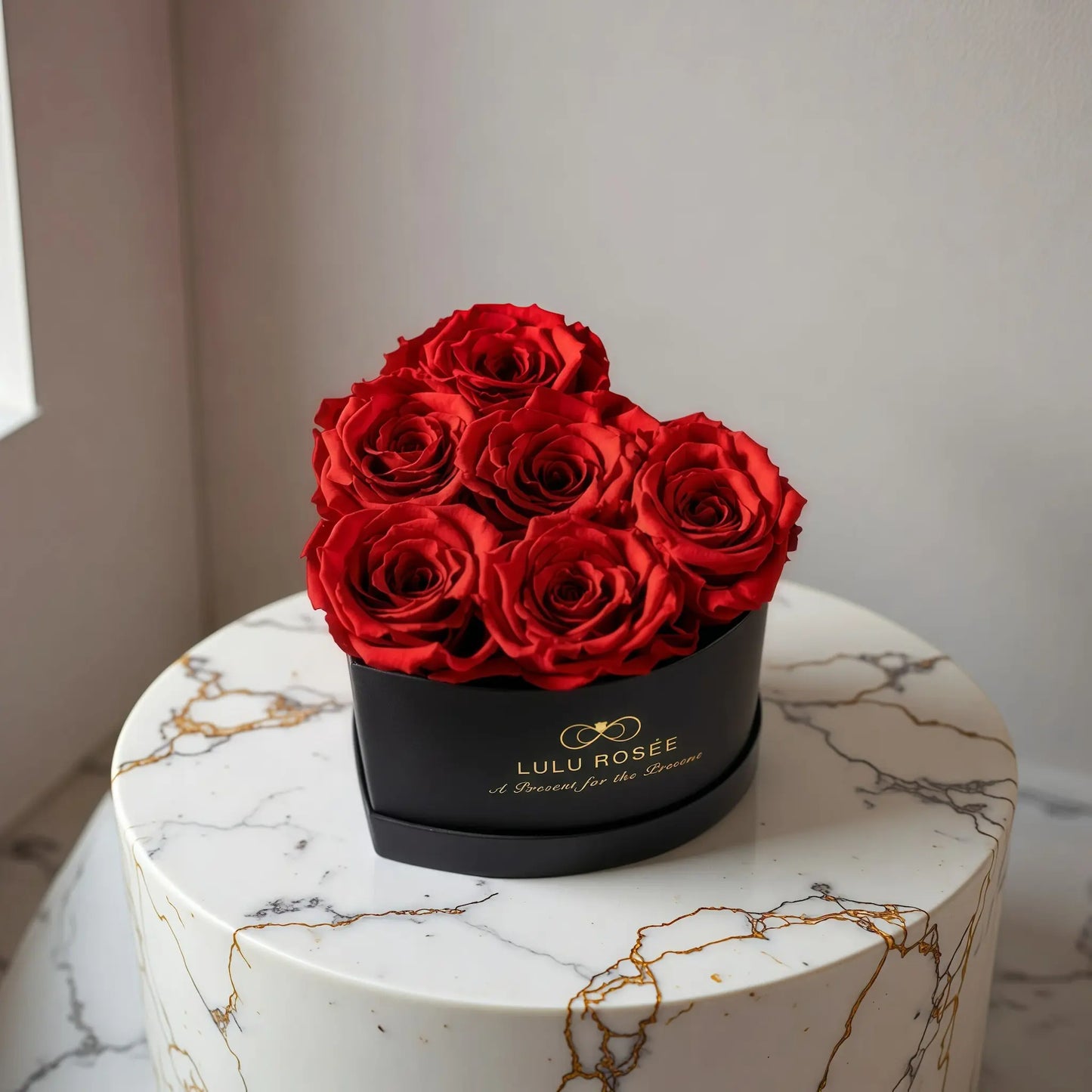 LULU ROSÉE baby heart box red roses black classic box displayed on a table