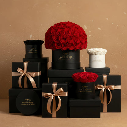 Collection of LULU ROSÉE flower boxes with red roses on a brown background