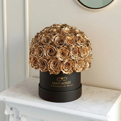LULU ROSÉE superdome box gold roses  black box on a marble surface