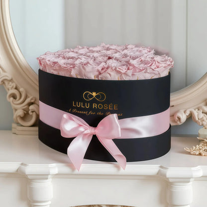 LULU ROSÉE large heart box light pink roses black classic box on a decorative surface