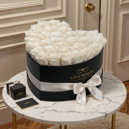 LULU ROSÉE large heart box pearl white roses black classic box on a marble table