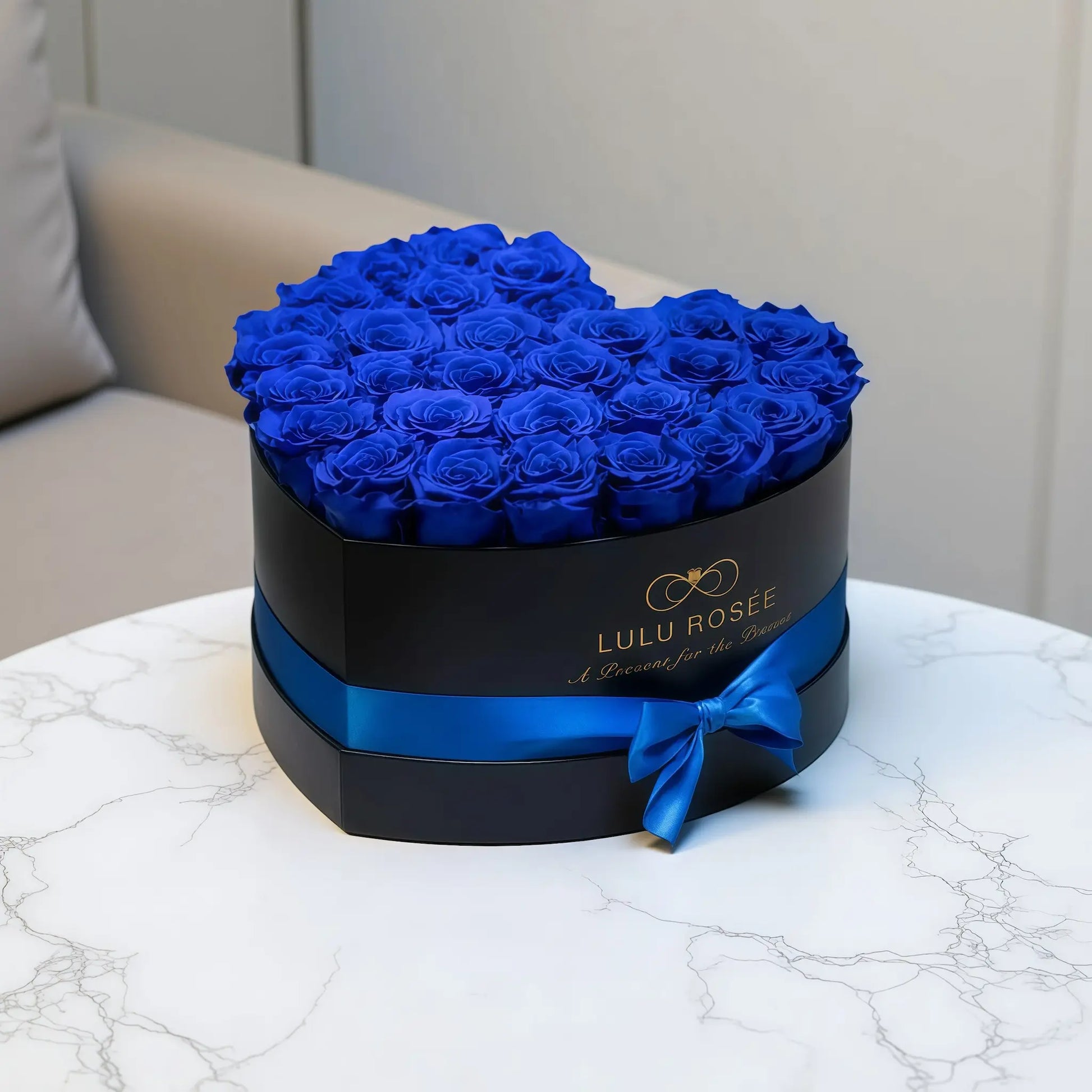 LULU ROSÉE large heart box royal blue roses black classic box in a modern living room