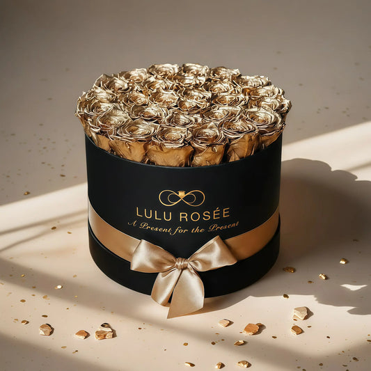 LULU ROSÉE large round box gold roses black classic box on a light background.