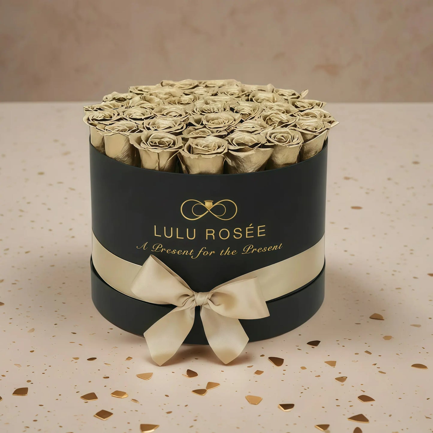 LULU ROSÉE large round box gold roses black classic box on stone floor