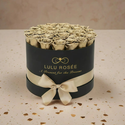 LULU ROSÉE large round box gold roses black classic box on stone floor