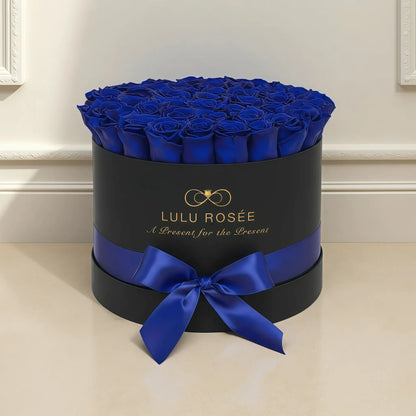 LULU ROSÉE large round box royal blue roses black classic box in a modern living room