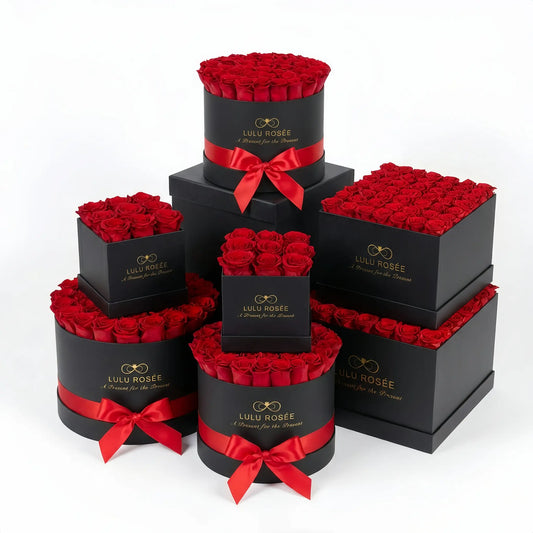 Stack of black boxes with red roses and ribbons, featuring Lulu Rosee branding.