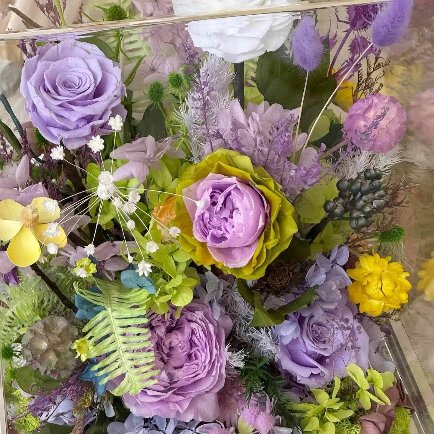 LULU ROSÉE Close-Up of Monet's Garden Floral Box, Vibrant Purple Roses and Greenery Preserved Blooms