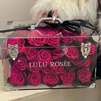 LULU ROSÉE Moyenne Eternal Acrylic Handbag Rose Box, medium transparent acrylic handbag-shaped gift box filled with rosy color preserved roses, soft fur backdrop close-up display, customizable flower colors, elegant everlasting floral gift for birthdays, anniversaries & romantic celebrations