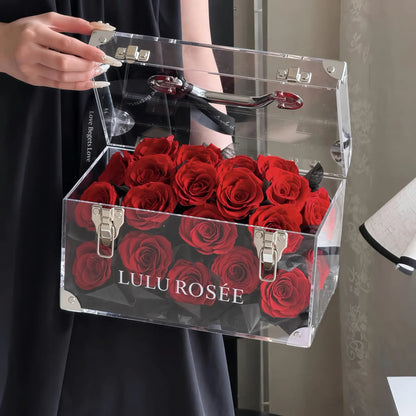 LULU ROSÉE Petite Eternal Acrylic Handbag Rose Box, small transparent acrylic handbag-shaped gift box filled with solid wine red preserved roses front closeup view, customizable flower color options, mini luxury everlasting floral souvenir for birthday, anniversary & romantic gift giving