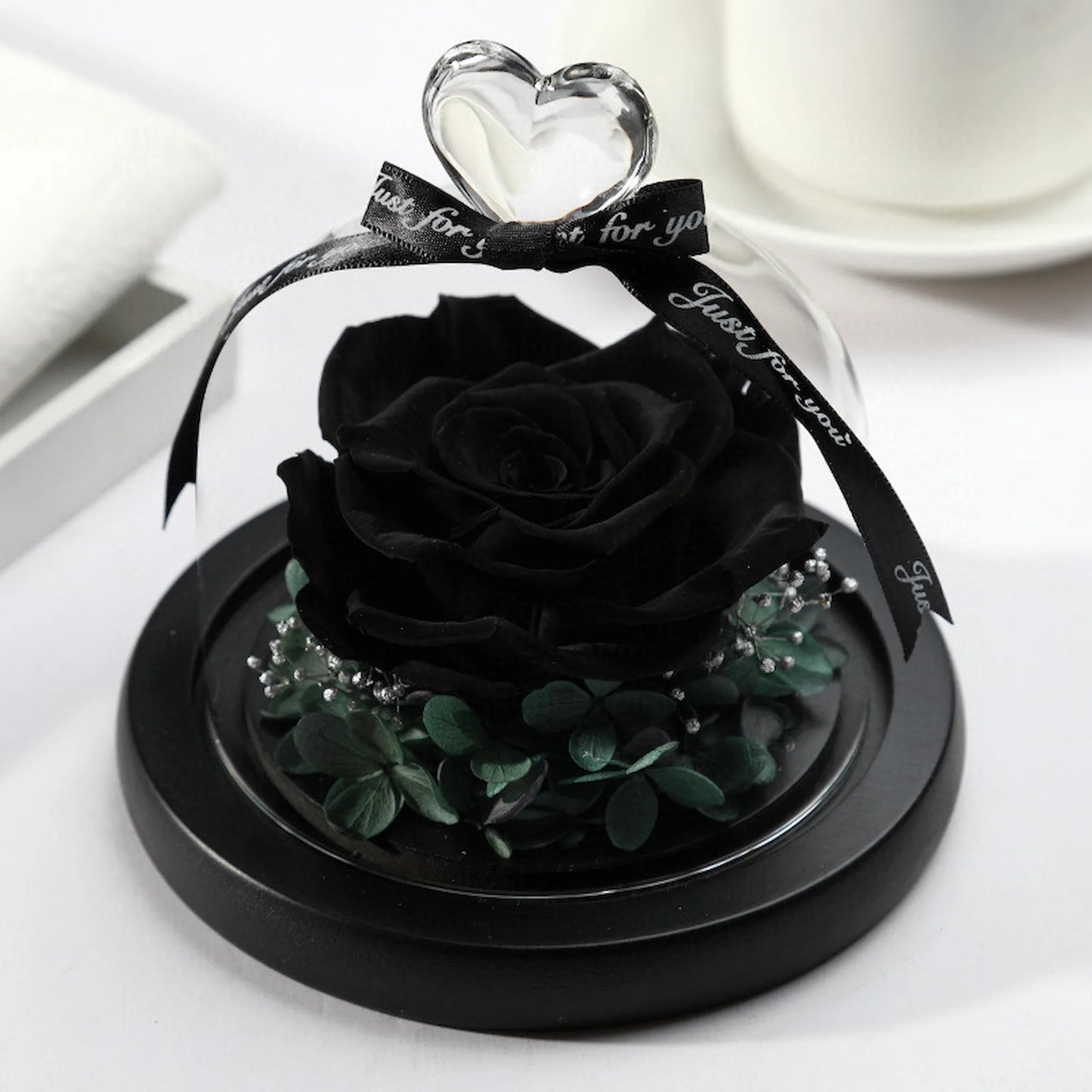 LULU ROSÉE single rose glass dome black rose in a minimalist living room