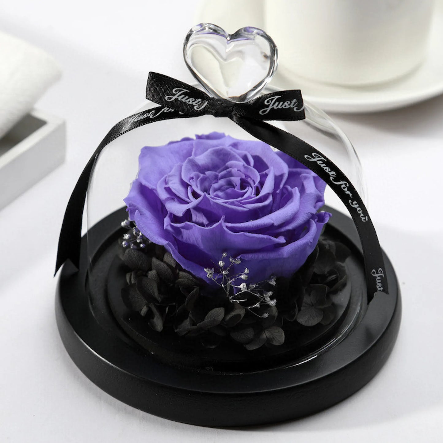 LULU ROSÉE single rose glass dome purple rose on a white surface.