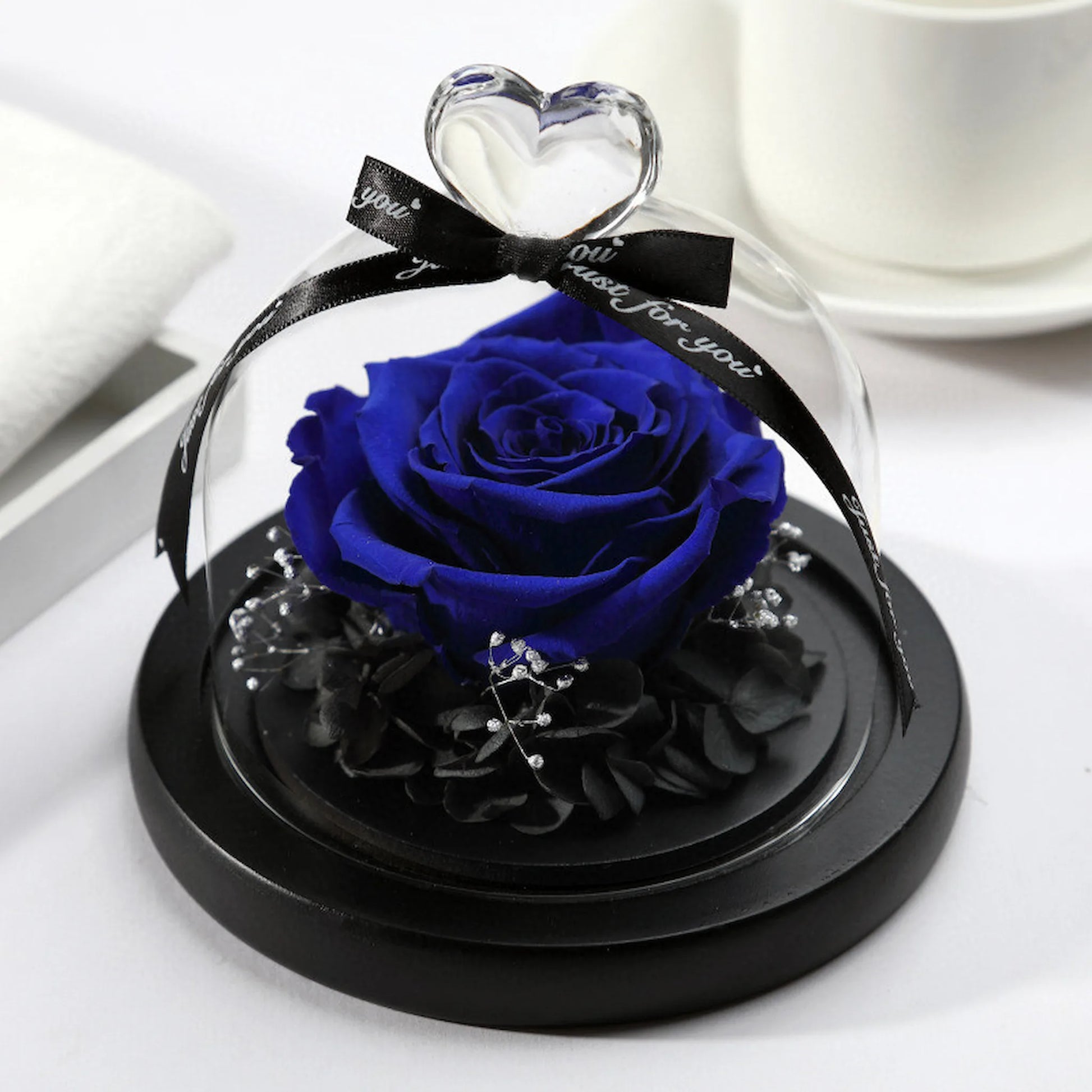 LULU ROSÉE single rose glass dome royal blue rose on a white surface