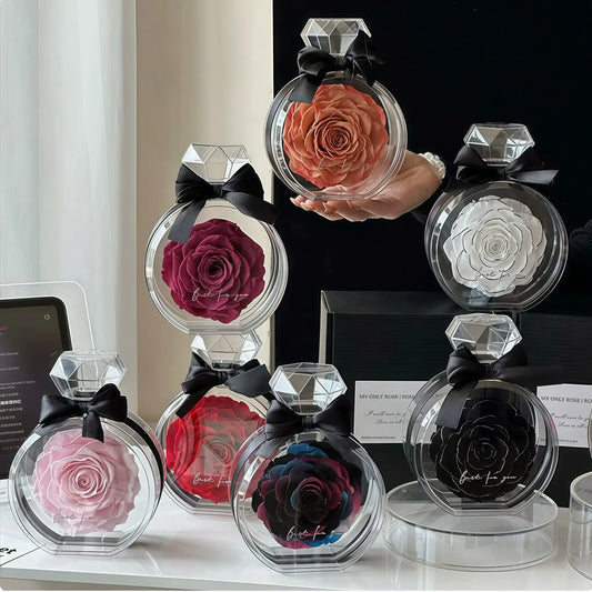 Collection of preserved roses in transparent diamond-shaped containers on a table.