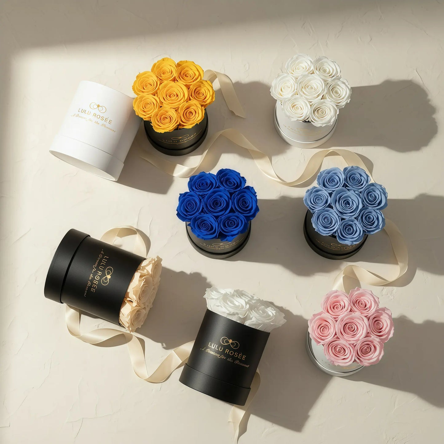 Collection of small round boxes with flowers on a light surface