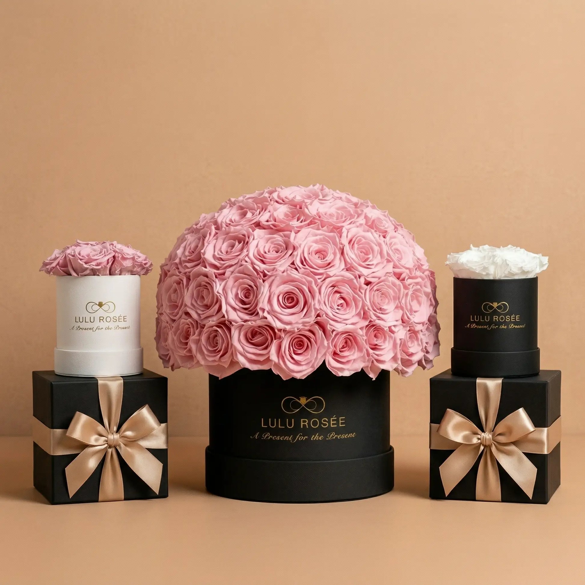 Lulu Rosée flower arrangement with smaller floral displays on a beige background