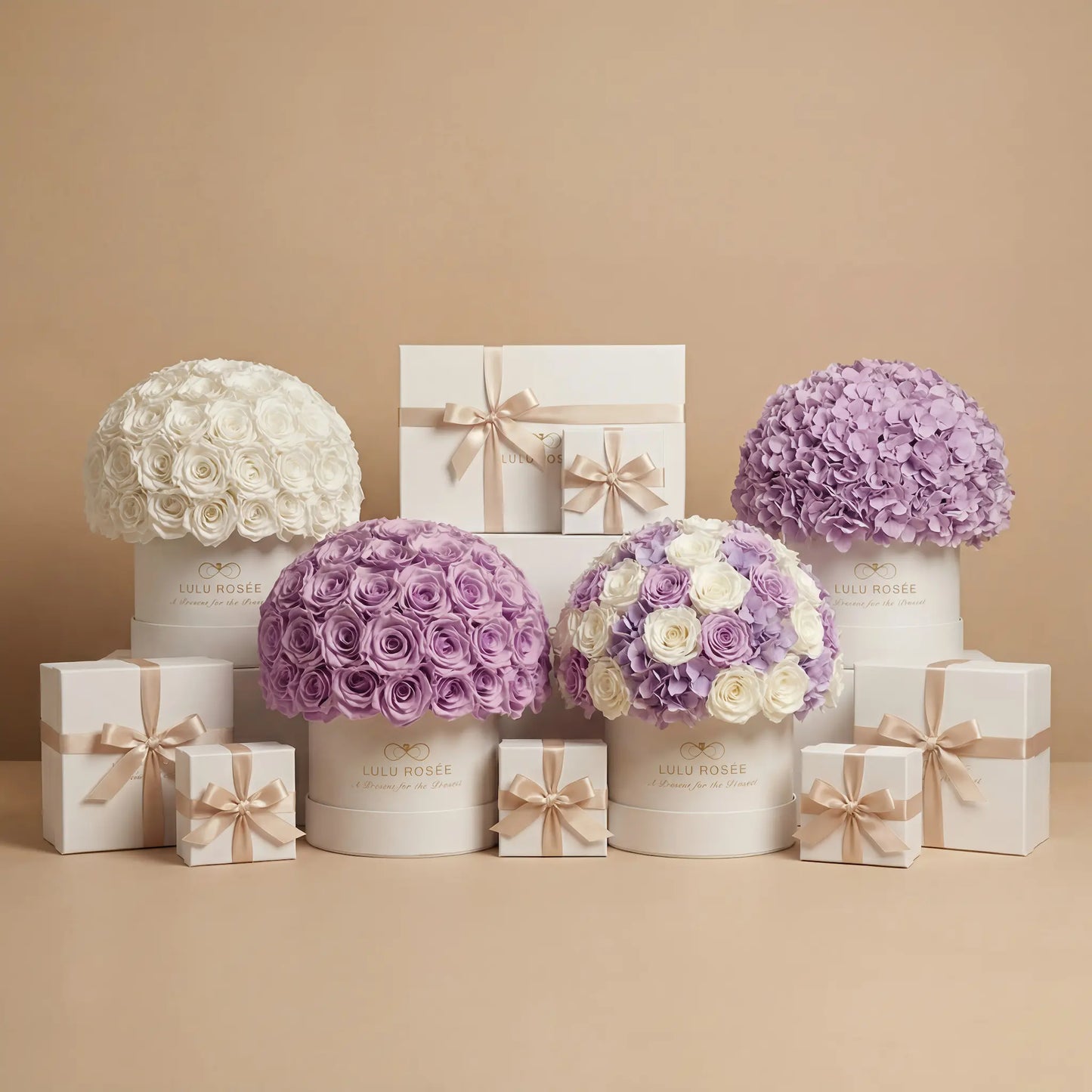 Decorative flower arrangements in white and purple boxes with matching gift boxes on a beige background
