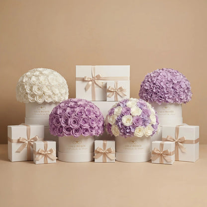 Decorative flower arrangements in white and purple boxes with matching gift boxes on a beige background